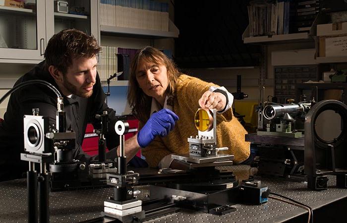 A professor and a student working on a project for an industry partner.